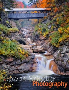 White Mountain Puzzles Inc releases Thomas Schoeller autumn covered bridge design